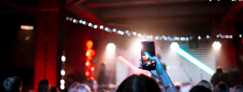Guests dancing at a backyard party with professional DJ setup