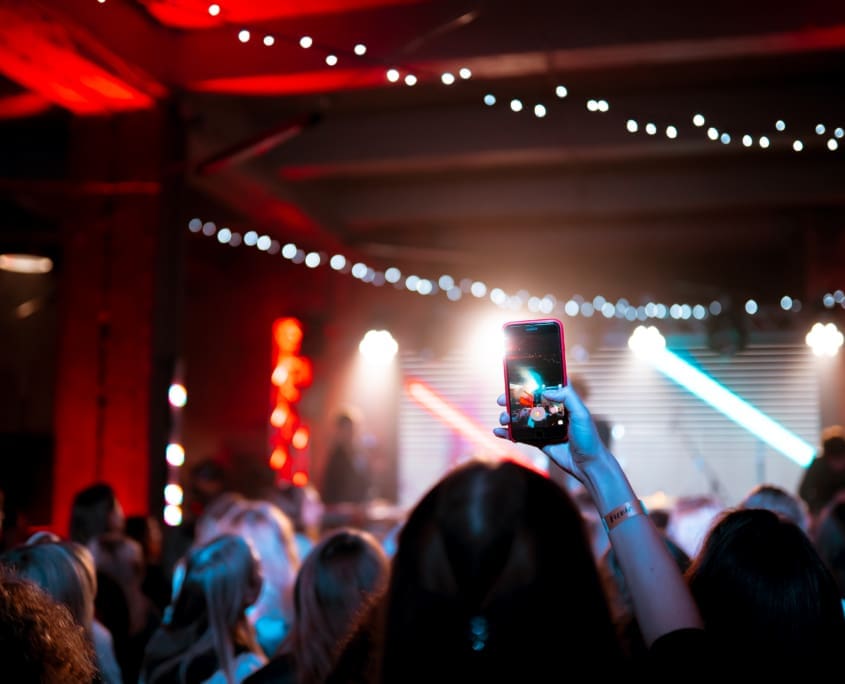 Guests dancing at a backyard party with professional DJ setup