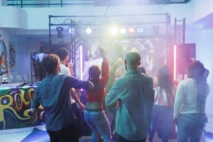 High school students dancing at a school event School dance DJ playing music for high school students