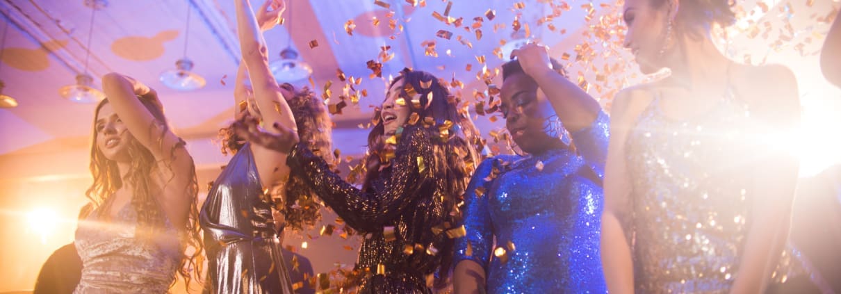 High school students dancing at prom with DJ in the background