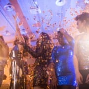 High school students dancing at prom with DJ in the background
