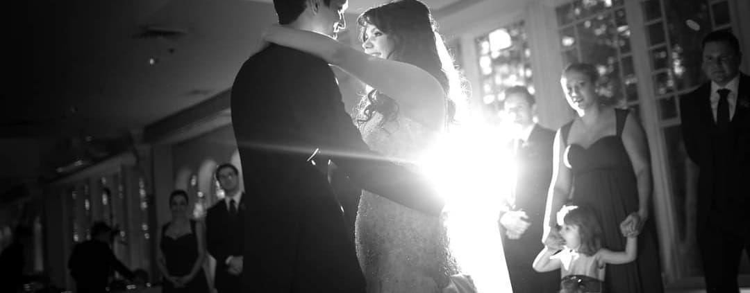 Bride and groom dancing at an elegant Fairfield wedding reception with DJ lighting
