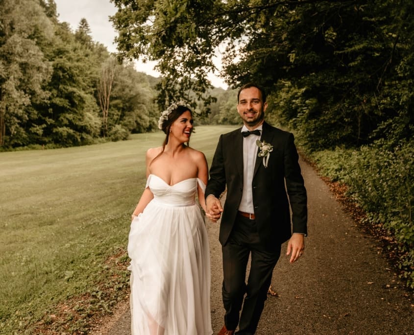 bride and groom walking down a path in Newburgh for their wedding