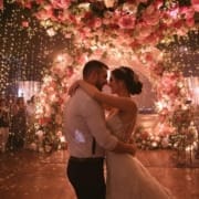 Wedding couple dancing as DJ sets the mood for a memorable moment
