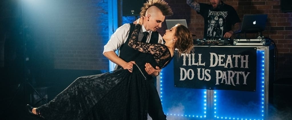 Bride and groom dancing while a wedding DJ plays at a stylish venue