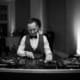 Professional DJ setup with newlyweds dancing nearby