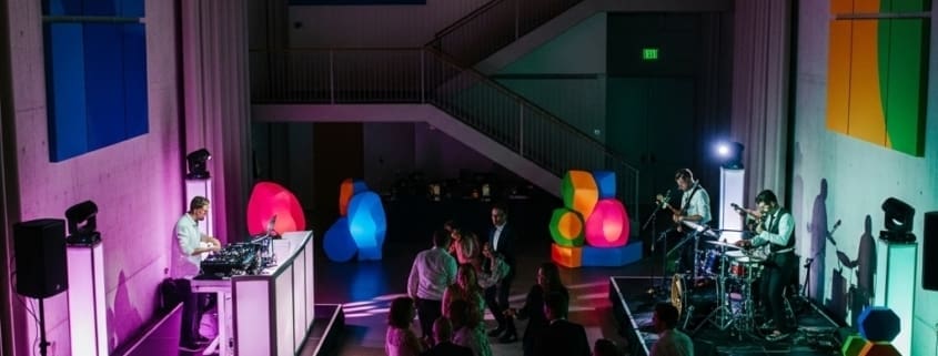 Wedding DJ and live band performing side by side at an upscale reception