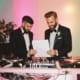 groom reviewing wedding checklist with DJ