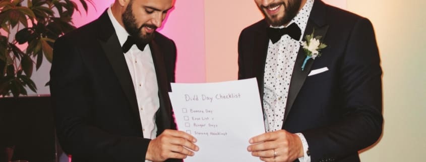 groom reviewing wedding checklist with DJ